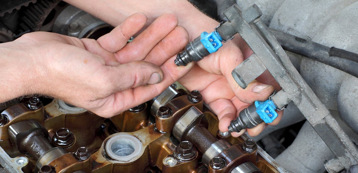 Mechanic Checking Faulty Fuel Injector